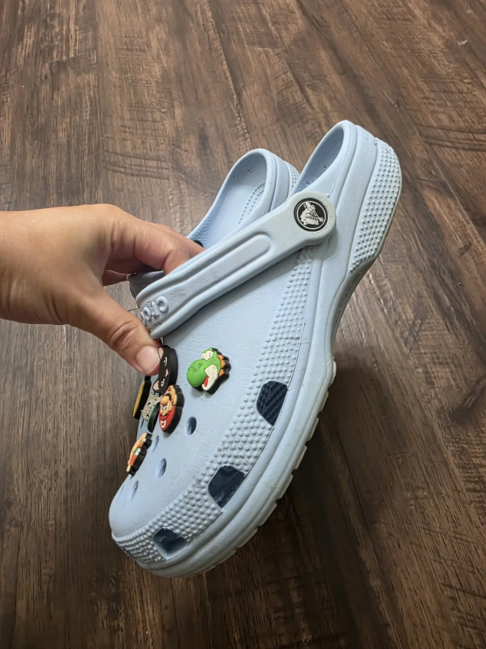 Crocs Classic Clog in a light blue color, size M6 / W8. Includes assorted decora